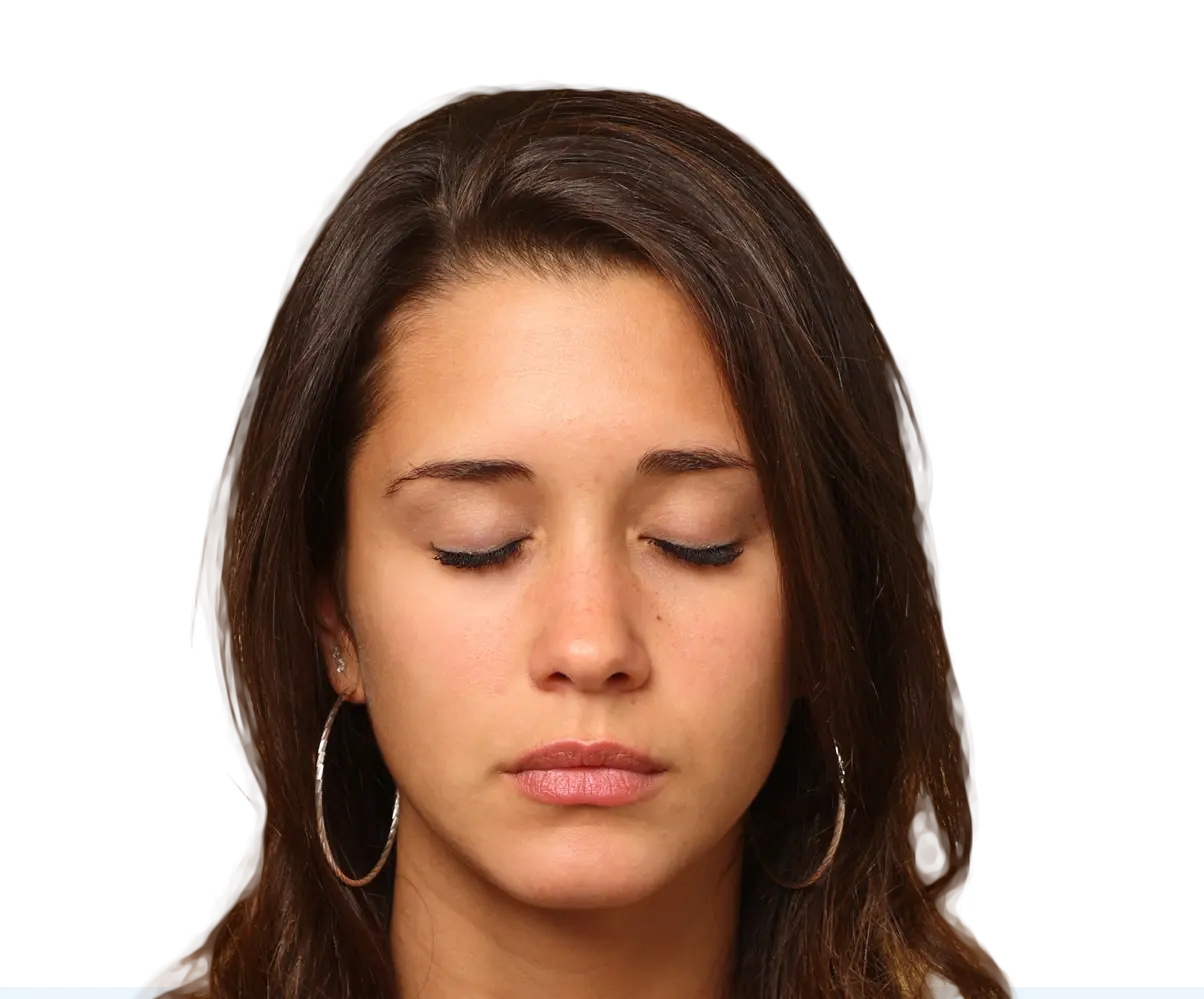 A woman meditating with eyes closed